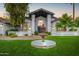 Elegant front yard featuring a circular driveway and meticulously maintained landscaping at 10662 E Carol Ave, Scottsdale, AZ 85258