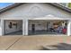 Spacious three car garage featuring white walls, organized storage, and a polished concrete floor at 10662 E Carol Ave, Scottsdale, AZ 85258