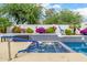 Inviting hot tub with blue tile accents and landscaped garden wall at 10662 E Carol Ave, Scottsdale, AZ 85258
