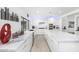 Contemporary kitchen featuring marble counters, stainless appliances, and modern lighting at 10662 E Carol Ave, Scottsdale, AZ 85258