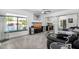 Cozy living room features plush gray carpet, a ceiling fan, a window view of the pool, and mirrored closet doors at 10662 E Carol Ave, Scottsdale, AZ 85258