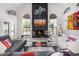 Comfortable living room with a fireplace, high ceiling, and ample seating at 10662 E Carol Ave, Scottsdale, AZ 85258