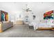 Spacious main bedroom with vaulted ceilings, stylish decor, ceiling fan, and neutral carpet at 10662 E Carol Ave, Scottsdale, AZ 85258