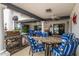 Comfortable outdoor patio with barbecue, ceiling fans, and dining with blue chairs at 10662 E Carol Ave, Scottsdale, AZ 85258