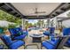 Cozy outdoor seating area with blue furniture, fire pit, and pool views at 10662 E Carol Ave, Scottsdale, AZ 85258