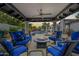 Inviting covered patio with comfortable seating around a cozy fire pit, ideal for outdoor entertaining at 10662 E Carol Ave, Scottsdale, AZ 85258