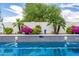 Sparkling swimming pool with blue tile accents and landscaped garden wall at 10662 E Carol Ave, Scottsdale, AZ 85258