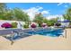 Refreshing backyard swimming pool with spa, blue tile accents, and lush landscaping at 10662 E Carol Ave, Scottsdale, AZ 85258