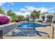 Sparkling swimming pool with spa, blue tile, lush landscape, and two lounge chairs at 10662 E Carol Ave, Scottsdale, AZ 85258