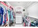 Spacious walk-in closet with ample shelving, hanging rods, and a central drawer unit for organized storage at 10662 E Carol Ave, Scottsdale, AZ 85258