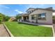 Spacious backyard showcasing a lush lawn, a built-in BBQ area, and manicured landscaping at 10718 E Vivid Ave, Mesa, AZ 85212