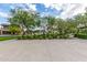 Community basketball court area surrounded by landscaped bushes and mature trees at 10718 E Vivid Ave, Mesa, AZ 85212