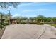 Community basketball court surrounded by lush greenery and mature shade trees at 10718 E Vivid Ave, Mesa, AZ 85212