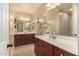 Spacious bathroom with dual vanities, modern lighting, and contemporary finishes at 10718 E Vivid Ave, Mesa, AZ 85212