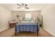 Bright bedroom features a comfortable bed, ceiling fan, and cozy décor at 10718 E Vivid Ave, Mesa, AZ 85212