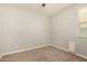 Spare bedroom with neutral walls and carpet and window with blinds at 10718 E Vivid Ave, Mesa, AZ 85212