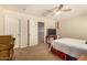 Bedroom featuring comfortable bed, ceiling fan, and two closets at 10718 E Vivid Ave, Mesa, AZ 85212