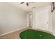 Minimal bedroom features a custom putting green and double door closet at 10718 E Vivid Ave, Mesa, AZ 85212