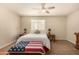 Light-filled bedroom with ceiling fan, comfortable bed, and neutral decor at 10718 E Vivid Ave, Mesa, AZ 85212