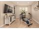 Bright exercise room with a large window, tiled flooring, and ample space for fitness equipment, creating an inviting workout area at 10718 E Vivid Ave, Mesa, AZ 85212