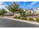 Inviting home exterior with a spacious driveway, well-kept lawn, and charming landscaping at 10718 E Vivid Ave, Mesa, AZ 85212
