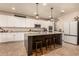 Modern kitchen boasts granite countertops, a central island with bar seating, stainless steel appliances, and ample cabinet space at 10718 E Vivid Ave, Mesa, AZ 85212