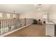 Inviting loft area features plush carpeting, a decorative wrought iron railing, and tranquil views of the neighborhood at 10718 E Vivid Ave, Mesa, AZ 85212