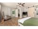 Bright main bedroom features a ceiling fan, sliding barn door, and access to a sunroom at 10718 E Vivid Ave, Mesa, AZ 85212