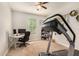 Functional office space featuring neutral walls, carpet flooring, and natural light from a large window at 10718 E Vivid Ave, Mesa, AZ 85212