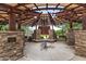 Covered outdoor lounge area with comfortable seating and shade canopy at 10718 E Vivid Ave, Mesa, AZ 85212