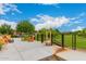 Relaxing outdoor patio with colorful Adirondack chairs, green lawn, and a scenic view with a walking bridge at 10718 E Vivid Ave, Mesa, AZ 85212