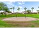 Community playground with swing set and seating surrounded by a green lawn at 10718 E Vivid Ave, Mesa, AZ 85212
