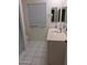 Bright bathroom with tile floors, a shower with glass doors, and ample counter space at 10721 W Mission Ln, Sun City, AZ 85351