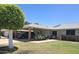 Charming single-story home featuring a covered carport and a well-maintained front yard with a beautiful, rounded tree at 10721 W Mission Ln, Sun City, AZ 85351