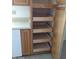 Kitchen cupboard with pull-out shelves, offering convenient and organized storage space at 10721 W Mission Ln, Sun City, AZ 85351