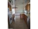 Bright kitchen features tile floors, wood cabinets, and stainless steel appliances at 10721 W Mission Ln, Sun City, AZ 85351