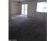 View of the expansive living room showcasing a sliding glass door and natural lighting at 10721 W Mission Ln, Sun City, AZ 85351
