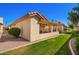 Exterior home view featuring a covered patio, showcasing the property's private outdoor living space within a well-kept community at 1120 N Val Vista Dr # 113, Gilbert, AZ 85234