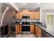 Updated kitchen featuring stainless steel appliances and wood cabinetry at 1120 N Val Vista Dr # 113, Gilbert, AZ 85234