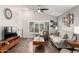 Well-lit living room with wood floors, ceiling fan and a bright front door at 1120 N Val Vista Dr # 113, Gilbert, AZ 85234