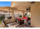 Relaxing covered patio, complete with comfortable seating, perfect for outdoor enjoyment, in a gated community with manicured landscaping at 1120 N Val Vista Dr # 113, Gilbert, AZ 85234