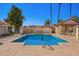 Community pool offers a refreshing escape with its inviting water and ample seating for relaxation under the clear blue sky at 1120 N Val Vista Dr # 113, Gilbert, AZ 85234
