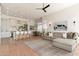Living room showcases a large sectional sofa and seamlessly connects with the kitchen and dining area in an open-concept design at 12366 N 129Th St, Scottsdale, AZ 85259