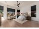 Spacious main bedroom with bright windows, wood floors, accent furniture and a ceiling fan at 12366 N 129Th St, Scottsdale, AZ 85259