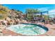 Relaxing community spa surrounded by natural rock and lush greenery, perfect for unwinding at 12366 N 129Th St, Scottsdale, AZ 85259