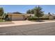 Charming single-story home with a well-manicured front yard and attached two-car garage, showcasing a bright and sunny day at 12927 W Shadow Hills Dr, Sun City West, AZ 85375