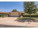 Exterior shot of a single-story home featuring a two-car garage, charming landscaping, and a well-maintained lawn at 12927 W Shadow Hills Dr, Sun City West, AZ 85375