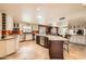 Open-concept kitchen with a large island, stainless steel appliances, and custom cabinets, seamlessly flowing into the living area at 12927 W Shadow Hills Dr, Sun City West, AZ 85375