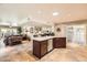 Spacious kitchen with a center island with a beverage cooler and seamless flow to the living area at 12927 W Shadow Hills Dr, Sun City West, AZ 85375
