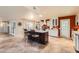 An open kitchen with a dark wood center island with bar stool seating and tile flooring at 12927 W Shadow Hills Dr, Sun City West, AZ 85375